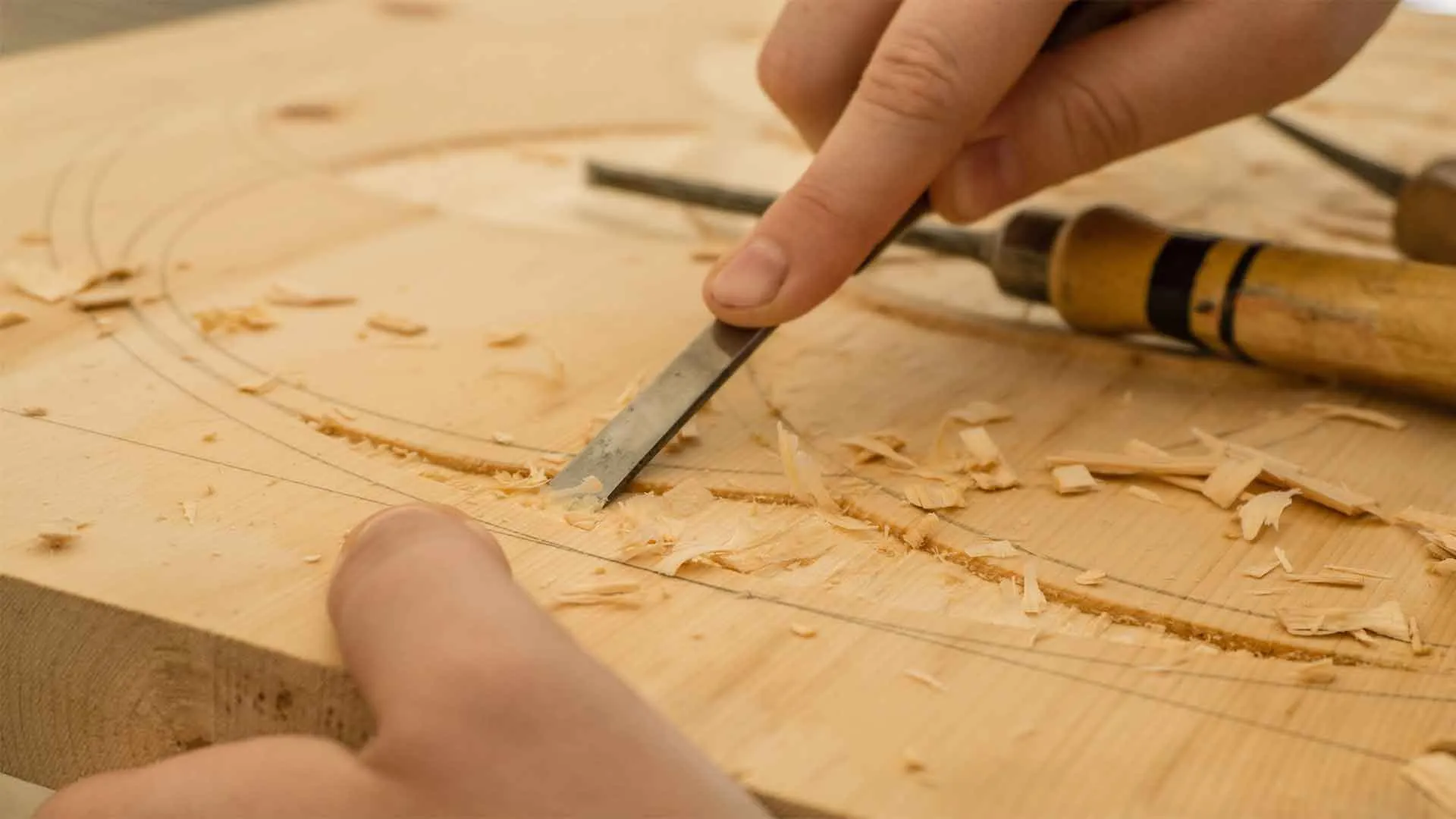 Close-up of precise wood joinery and chisels